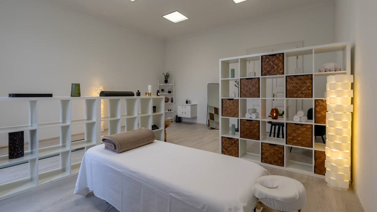 A bright massage room with a massage table